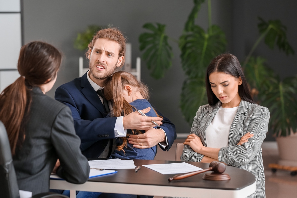 young couple and their daughter visiting divorce lawyer in office