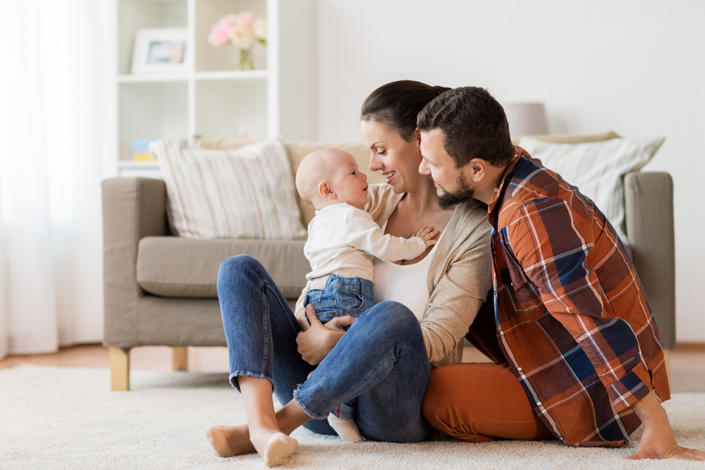 happy mother, father with baby at home