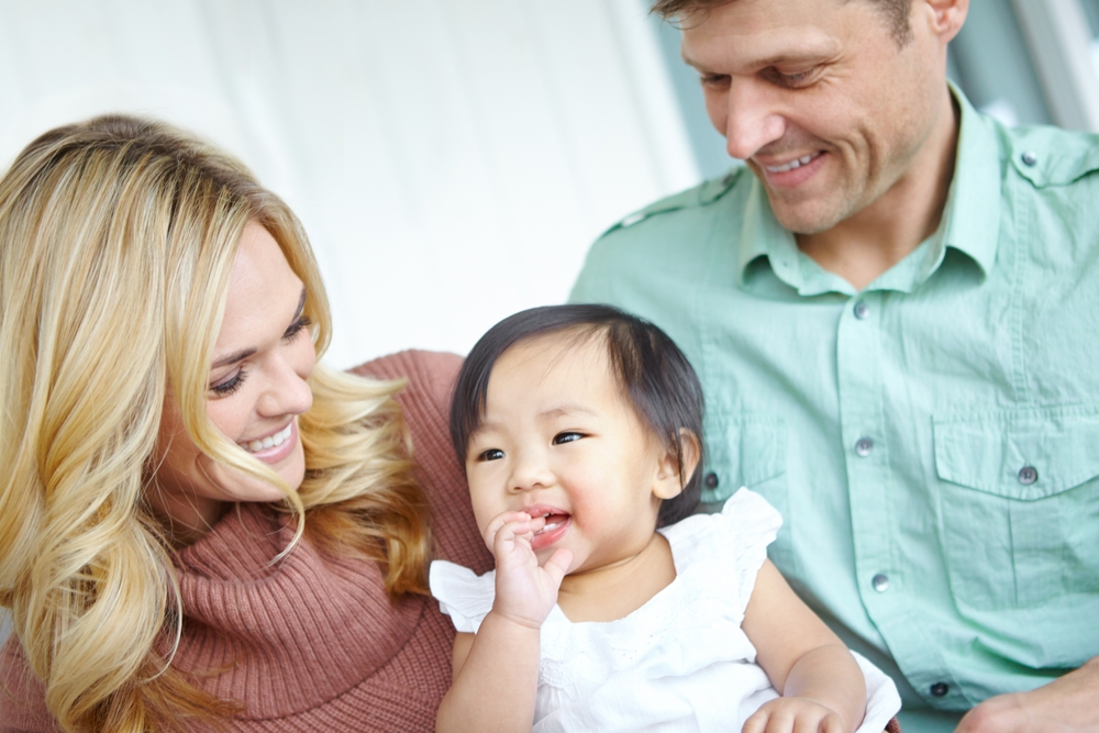 family and foster baby in home for love, support or bonding together