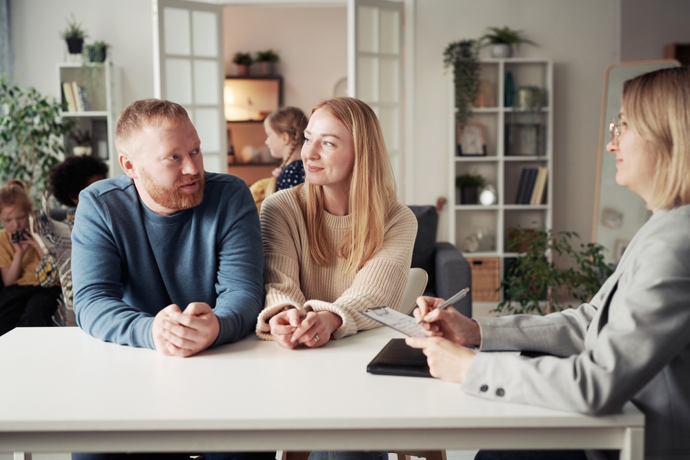 Couple talking to social worker about adoption
